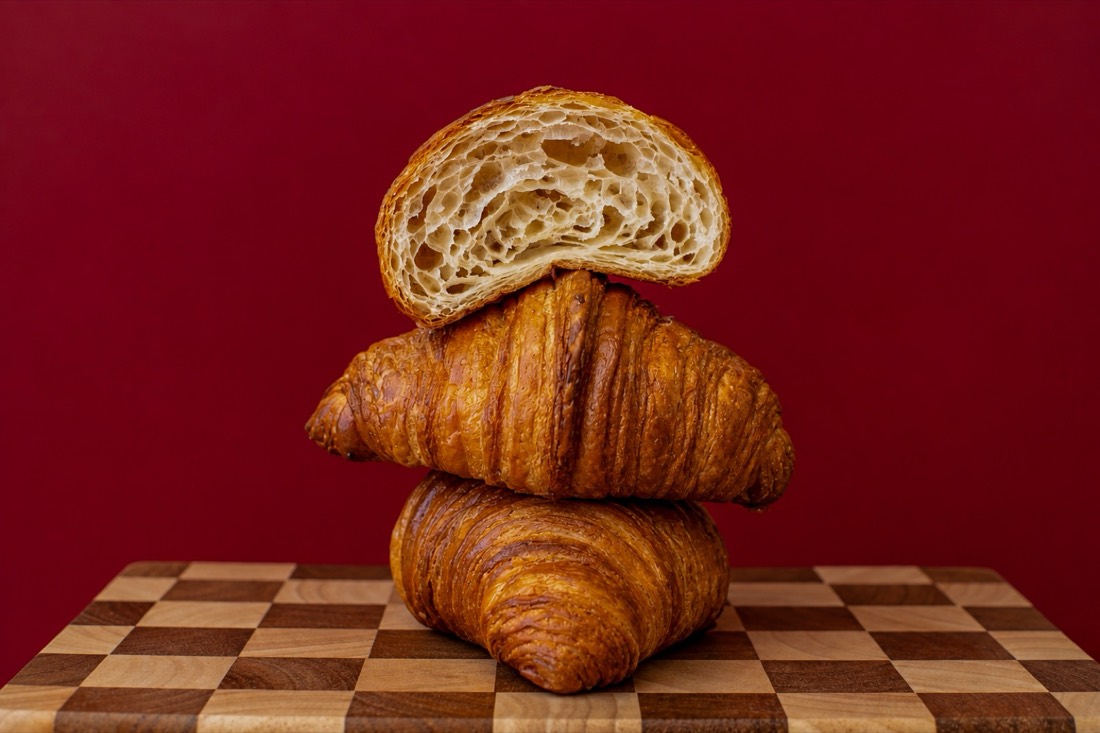 Croissants stacked on a checkerboard board